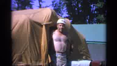 Colorado USA (1959): A Shirtless Caucasian Man Stepping Out Of A Brown Tent