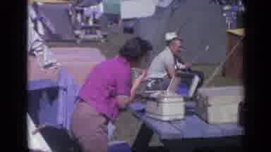 Colorado USA (1959): At A Campsite A Woman Bends Towards A Picnic Table Applying
