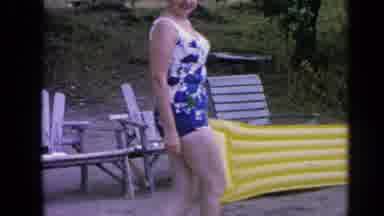 Greenwood Lake New York (1964): Woman Walking Along Side Of Lake Wearing A Purple
