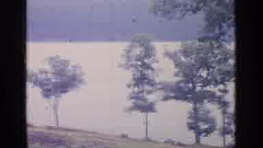 Greenwood Lake New York (1964): Camera Pans Over Lake With Trees In Foreground And