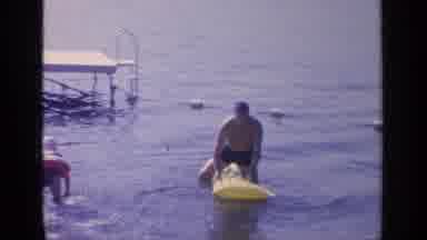 Greenwood Lake New York (1964): Man In Yellow Alligator Float Beside The Pier In