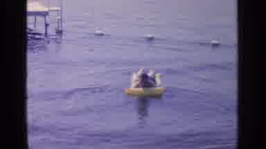 Greenwood Lake New York (1964): In A Roped Off Section Of A Lake A Man Lies On A