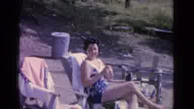 Greenwood Lake New York (1964): Woman In A Blue Patterned Swimsuit Sitting In A