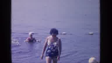 Greenwood Lake New York (1964): Woman In One Piece Swimsuit Walks Towards Shore As