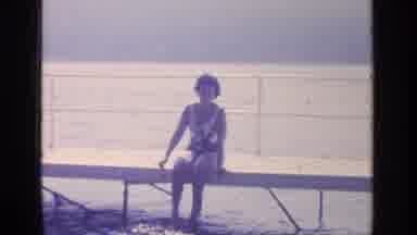 Greenwood Lake New York (1964): Lady Sitting On Dock Dipping Her Toes In The Water