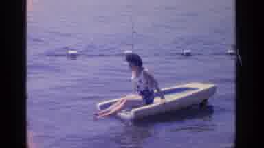 Greenwood Lake New York (1964): A Woman Wearing A Sleevless Top And Shorts Sits On