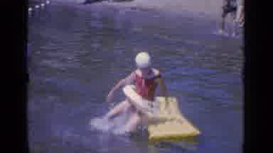 Greenwood Lake New York (1964): A Little Girl Jumps Up And Down On Toy In A Lake