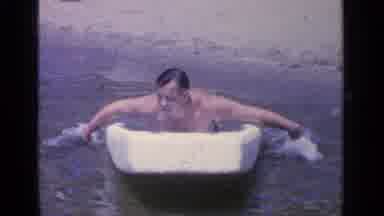 Greenwood Lake New York (1964): Man Swimming On A Styrofoam Board On The Shore