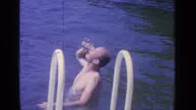Greenwood Lake New York (1964): Person Standing In Water Drinking A Beverage From