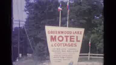 Greenwood Lake New York (1964): Two Flags Top Of Motel Sign Waving In Breeze On