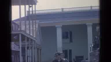Flushing Meadows New York (1964): People Walking Past Green Building On A Sunny