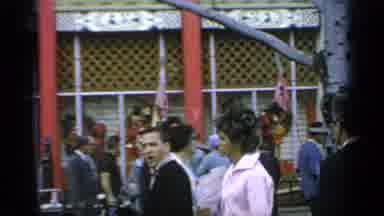 Flushing Meadows New York (1964): Couple Walks Past Crowd In Front Of Building