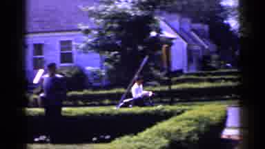 Long Island New York (1965): Child Riding A Bicycle When He Runs By A Neighbor