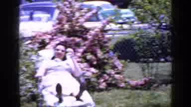 Long Island New York (1965): Woman Wearing White Dress Sits In Lounge Chair Next