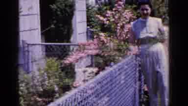 Long Island New York (1965): Woman Leans Against Fence As Shot Moves To Yard Then