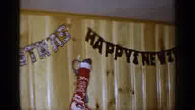 LONG ISLAND NEW YORK-1965: Happy New Year Banner and Christmas Stocking in Wood Panel Room