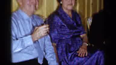 Long Island New York (1965): Man Wearing Blue Shirt Hold Glass While Sitting Next