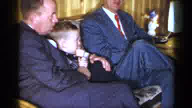 Long Island New York (1965): Two Men In Suits Sitting Together On A Couch Holding
