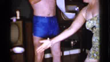 Mineola New York (1966): Man Wearing Blue Short Unrolls Tissue Paper Next To