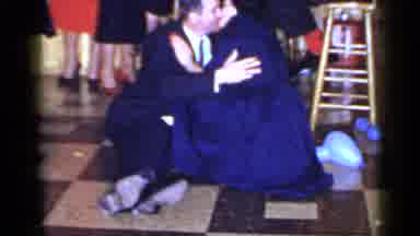 Mineola New York (1966): A Man In A Suit Kisses Women In A Dress Sitting On The