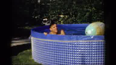 Mineola New York (1966): Man Floating On A Large Beach Ball On His Stomach In A