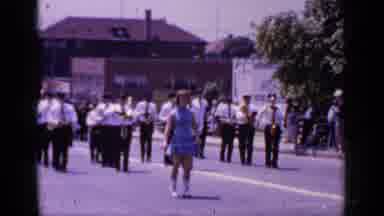 Mineola New York (1966): Majorette Wearing Blue Dress Marches In Front Of Band On