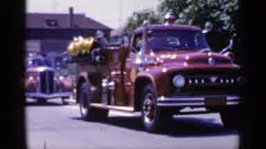 Mineola New York (1966): Two Old Red Vehicles From Decades Ago Driving Down Street