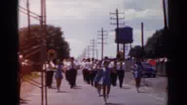 Mineola New York (1966): Marching Band With People Dancing Marching Down The Road