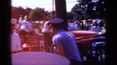 Mineola New York (1966): Group Of People Wearing White Shirts Riding On Red Truck