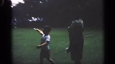 Massachusetts USA (1968): A Woman And A Small Boy In A Grass Yard Talking