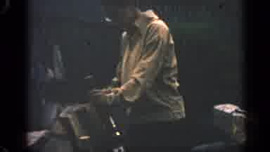 Massachusetts USA (1969): A Guy Hammering Something Into The Wood Outside In The
