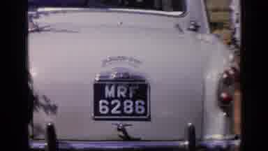 India (1970): A Green Volkswagen Besides A White Car Surrounded By Palm Trees