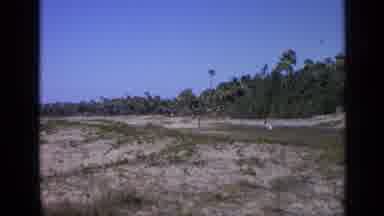 India (1970): A Runner Runs Down A Dirt Track While Women Wearing White Dresses A