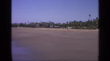 India (1970): Single Person Playing In The Ocean On Desolate Beach With Scenic