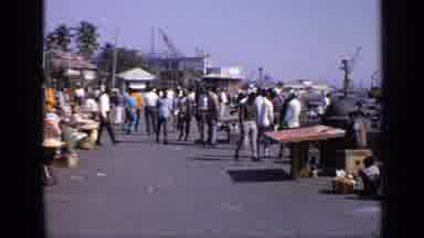 India (1970): People Walking Around The Day And Observing What's On The Market