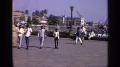 India (1970): A Group Of Men Relaxing On A Pier That Is Overlooking A Lake