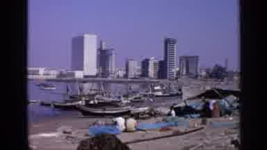 India (1970): People On The Shore With The Boats On The Stand By Overlooking The