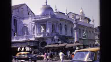India (1970): A Busy Street With People Walking And Driving With An Ancient Indian