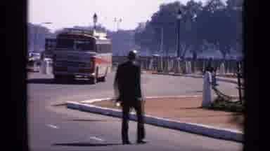 India (1970): Person Cuts Across Street In Traffic Then Scene Of Arch