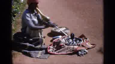 India (1970): Person Playing Their Flute As Their Cobra Dances Then He Pets The