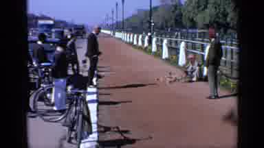 India (1970): A Person Sitting Along A Fence Playing An Instrument And Drawing A