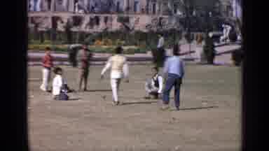 India (1970): Someone Crouched In A Blanket And Kids Playing Soccer In A Meadow
