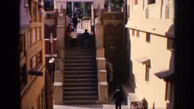 India (1970): A Man Waits For A Family To Pass Him On The Stairs Before Jumping