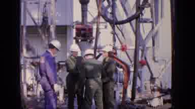 United Kingdom (1970): Four Workers Three In Green And One In Blue Hold On To A