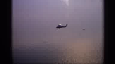 United Kingdom (1970): Helicopter Being Filmed From The Distance As It Flies Over