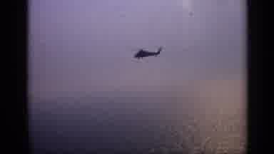 United Kingdom (1970): Boat Adrift In Sea With Helicopter Flying Over It
