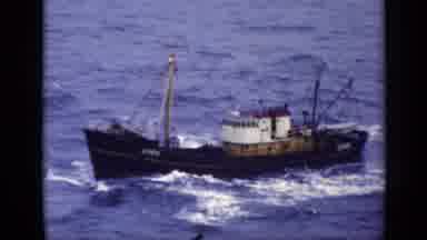 United Kingdom (1970): Brown Boat In Open Water On A Clear Day