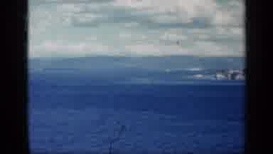 CUBA-1962: Coastal View With Water, Sky, and Distant Mountains