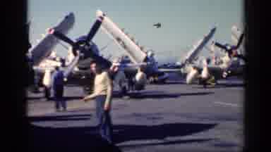 CUBA-1962: Man Standing In Front Of Large Propeller Planes On Aircraft Carrier
