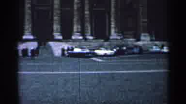 Cuba (1962): Sweeping Right A Cobblestone Lot With Cars In Front Of A Large